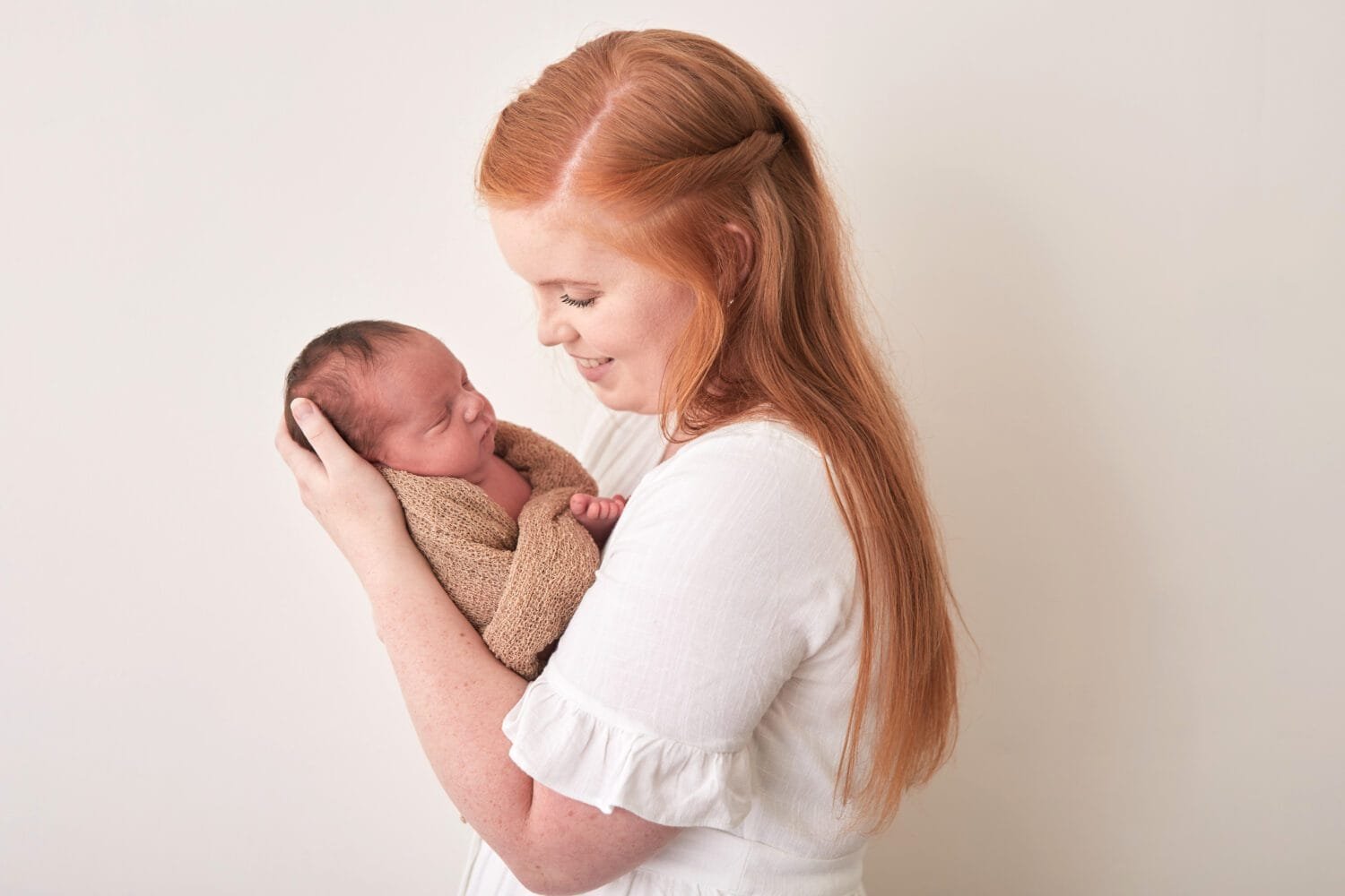 redhead mother with newborn baby