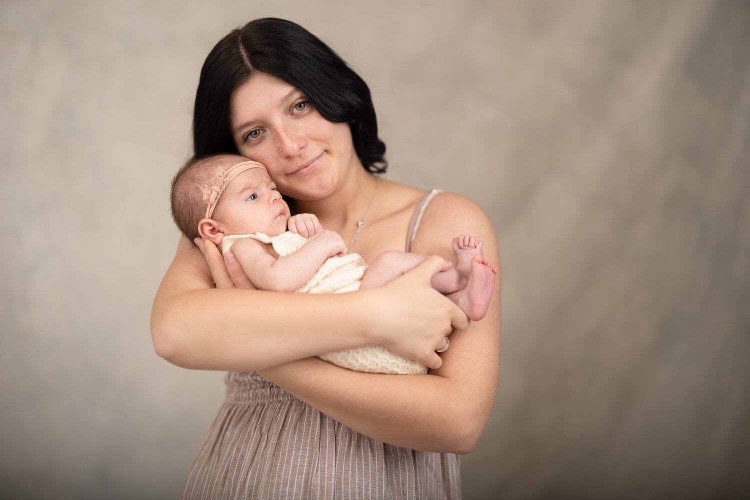 Mother with newborn baby girl in studio