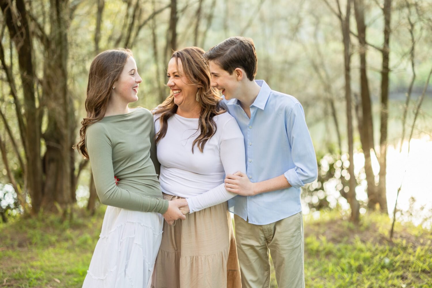 Family photoshoot pose with mother and children outdoors