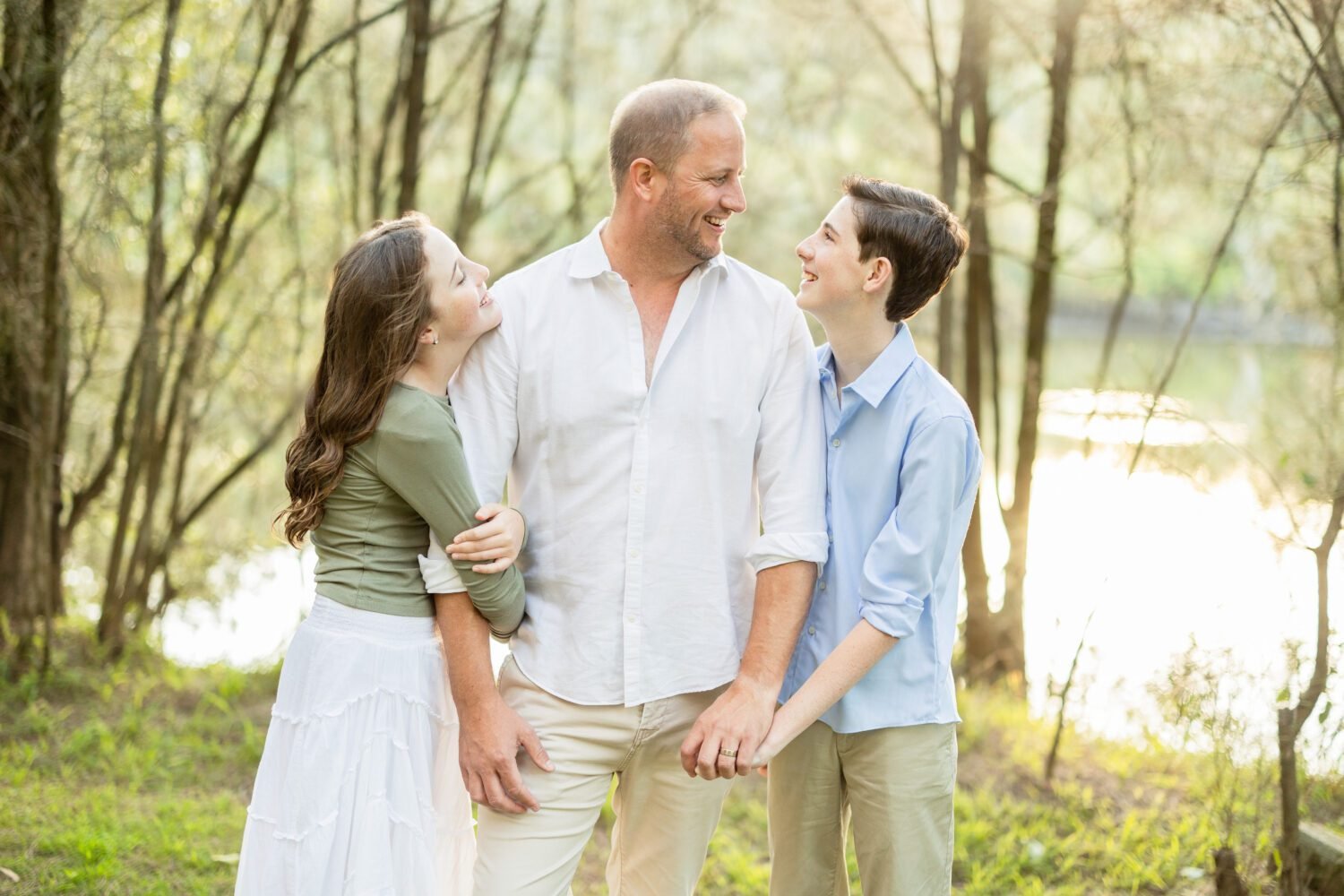 Family photoshoot pose with father and children outdoors