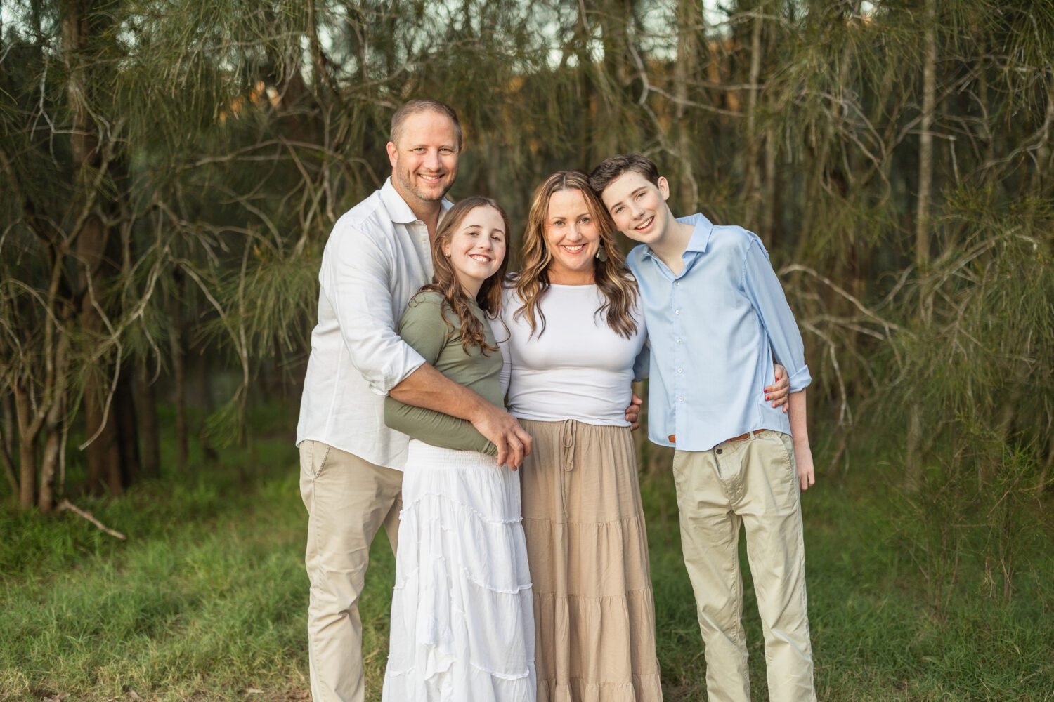 Family photoshoot pose on beach with boy and girl