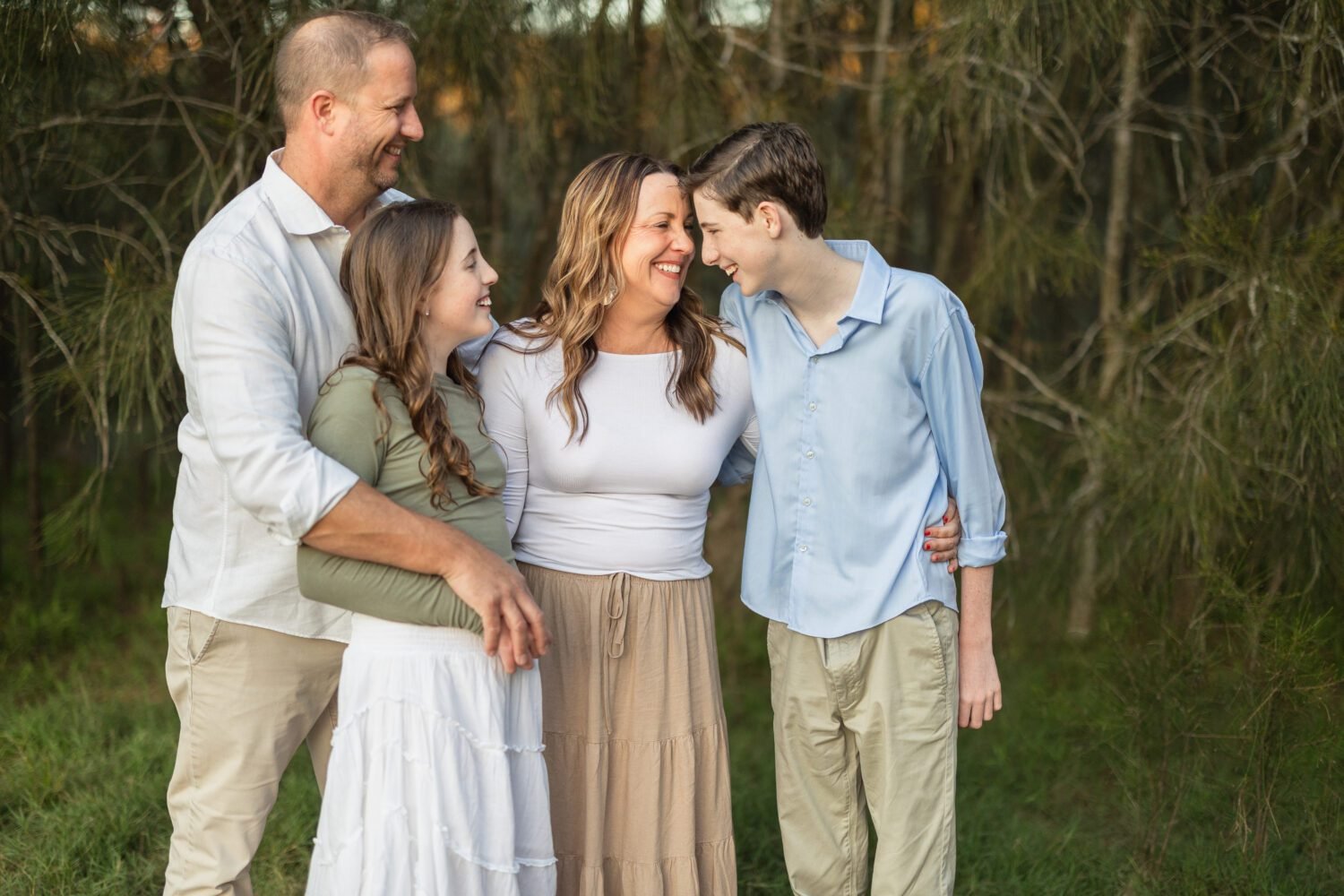 Family photoshoot pose on beach with boy and girl